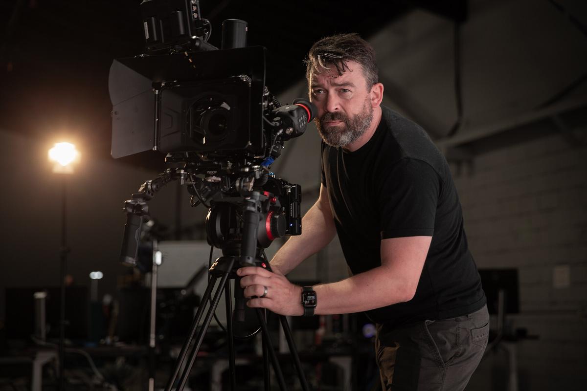 Filming with a tracked virtual production camera in front of an LED wall.